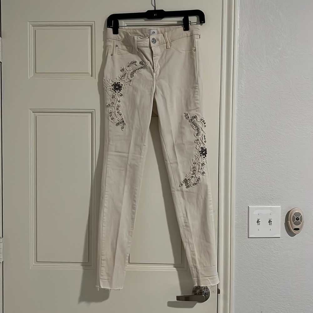 Cream skinny jeans with crystal and lace detailing